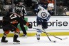 Winnipeg Jets left wing Nikolaj Ehlers, right, shoots the puck against Anaheim Ducks defenceman Scott Harrington during the second period of an NHL hockey game in Anaheim, Calif., Thursday, March 23, 2023. Ehlers will miss Thursday's regular-season finale against the Colorado Avalanche with an upper-body injury, head coach Rick Bowness told reporters. THE CANADIAN PRESS/AP/Alex Gallardo