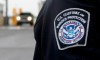 A U.S. Customs and Border Protection officer stands near a security booth as vehicles approach in Detroit, Mich, on Monday, June 1, 2009. U.S. officials say at least seven of the nine men caught crossing the border from Canada this week in southeast Manitoba are Mexican citizens. THE CANADIAN PRESS/Dave Chidley