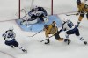 Winnipeg Jets goaltender Connor Hellebuyck (37) blocks a shot by Vegas Golden Knights center Brett Howden (21) during the first period of Game 1 of an NHL hockey Stanley Cup first-round playoff series Tuesday, April 18, 2023, in Las Vegas. THE CANADIAN PRESS/AP, John Locher