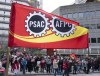 A flag flies as Public Service Alliance of Canada members walk the picket line outside government buildings, Friday, April 21, 2023 in Gatineau, Quebec. THE CANADIAN PRESS/Adrian Wyld