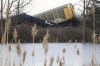 FILE - Multiple cars of a Norfolk Southern cargo train lie toppled on one another after derailing at a train crossing near Springfield, Ohio, on March 4, 2023. Federal regulators are warning railroads Thursday, April 27, that the long trains they favor can cause all kinds of problems and contribute to derailments, so they want the railroads to ensure their training and operating procedures account for that. (Bill Lackey/Springfield-News Sun via AP, File)