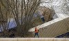 Recovery work is shown at the scene of a train derailment along Hwy 35 Thursday, April 27, 2023 in Crawford County just south of DeSoto, Wis. A freight train derailed along the Mississippi River in southwestern Wisconsin Thursday, possibly injuring one crew member and sending two cars into the water, officials said. (Mark Hoffman/Milwaukee Journal-Sentinel via AP)