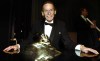 Gordon Lightfoot poses with an award after being inducted into the Canadian Songwriters Hall of Fame in Toronto on December 3, 2003. THE CANADIAN PRESS/Tobin Grimshaw