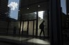 A man walks though a downtown Toronto office building with other buildings reflected in a window in this June 11, 2019 photo. Statistics Canada is set to release its April labour force survey this morning, providing updated numbers on employment levels in the country. THE CANADIAN PRESS/Graeme Roy