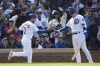 Chicago Cubs' Nick Madrigal, left, is greeted by Nico Hoerner after scoring on Miguel Amaya's pinch-hit single during the eighth inning of a baseball game against the Miami Marlins on Saturday, May 6, 2023, in Chicago. (AP Photo/Charles Rex Arbogast)