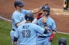 Toronto Blue Jays' Whit Merrifield, right, celebrates with Matt Chapman, left, and Brandon Belt (13) as he returns to the dugout after hitting a three-run home run off Pittsburgh Pirates starting pitcher Roansy Contreras during the third inning of a baseball game in Pittsburgh, Sunday, May 7, 2023. (AP Photo/Gene J. Puskar)