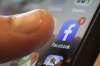 FILE - An iPhone displays the Facebook app in New Orleans, Aug. 11, 2019. Facebook says it is not dead. It’s not even just for “old people,” as young people have been saying for years. The social media platform born before the iPhone is approaching two decades in existence. (AP Photo/Jenny Kane, File)