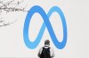 A person stands in front of a Meta sign outside of the company's headquarters in Menlo Park, Calif., Tuesday, March 7, 2023. A representative for Meta says it has a team that is working toward blocking news for its Canadian users on Facebook and Instagram. THE CANADIAN PRESS/AP-Jeff Chiu