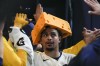 Milwaukee Brewers' Willy Adames is congratulated after hitting a three-run home run during the seventh inning of a baseball game against the Los Angeles Dodgers Monday, May 8, 2023, in Milwaukee. (AP Photo/Morry Gash)