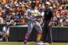Pittsburgh Pirates' Andrew McCutchen, center left, reacts at first base during the first inning of a baseball game against the Baltimore Orioles, Sunday, May 14, 2023, in Baltimore. (AP Photo/Julia Nikhinson)