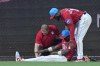 A trainer and Miami Marlins left fielder Bryan De La Cruz help center fielder Jazz Chisholm Jr. after an injury during the eighth inning of a baseball game against the Cincinnati Reds, Saturday, May 13, 2023, in Miami. (AP Photo/Wilfredo Lee)