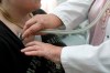 A doctor examines a patient with a stethoscope in her doctor's office in Stuttgart, Germany, Monday, April 28, 2008. THE CANADIAN PRESS/AP/Thomas Kienzle