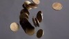 Falling Canadian loonies are pictured in Vancouver on September 22, 2011. Canada's housing agency says the country has the highest level of household debt in the G7, making its economy vulnerable to a global economic crisis. THE CANADIAN PRESS/Jonathan Hayward