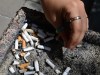 A smoker puts out a cigarette in a public ashtray in Ottawa on May 31, 2016. Three national health organizations want Canada's premiers to push for initiatives to reduce smoking during settlement negotiations with major tobacco companies, which provinces sued to recoup health-care costs. THE CANADIAN PRESS/Sean Kilpatrick