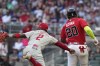 Philadelphia Phillies third baseman Josh Harrison (2) tags out Atlanta Braves' Marcell Ozuna during the second inning of a baseball game Friday, May 26, 2023, in Atlanta. (AP Photo/Brynn Anderson)