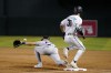 Arizona Diamondbacks' Jake McCarthy (31) beats out an infield single as the late throw gets away from Colorado Rockies first baseman Nolan Jones, left, during the fourth inning of a baseball game Tuesday, May 30, 2023, in Phoenix. (AP Photo/Ross D. Franklin)