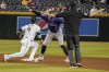 Colorado Rockies' Brenton Doyle (9) mimics umpire John Tumpane in doing a safe call after stealing second base against Arizona Diamondbacks' Ketel Marte during the fifth inning of a baseball game Thursday, June 1, 2023, in Phoenix. (AP Photo/Darryl Webb)