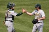 Oakland Athletics relief pitcher Trevor May, right, celebrates with catcher Shea Langeliers after getting the final out of a baseball game against the Pittsburgh Pirates in Pittsburgh, Wednesday, June 7, 2023. (AP Photo/Gene J. Puskar)