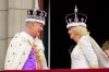 Britain's King Charles III and Queen Camilla look at each other as they stand on the balcony of the Buckingham Palace after their coronation, in London, Saturday, May 6, 2023. (Leon Neal/Pool Photo via AP)