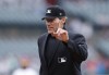 FILE - Home plate umpire Ángel Hernández signals during a baseball game between the Detroit Tigers and the Minnesota Twins, Sept. 1, 2019, in Detroit. A federal appellate court panel appeared to be skeptical Thursday, June 8, 2023, of an attempt by umpire Ángel Hernández to reinstate his race discrimination lawsuit against Major League Baseball. (AP Photo/Carlos Osorio, File)