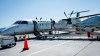 A passenger boards a WestJet Encore Bombardier Q400 twin-engined turboprop aircraft in Kamloops, Saturday, June 3, 2023.&nbsp;WestJet and Swoop pilots ratified their collective agreement after a bargaining process that saw the threat of a strike snarl many Canadians' long weekend plans. THE CANADIAN PRESS/Jeff McIntosh