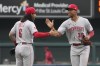 Cincinnati Reds' Will Benson (30) and Jonathan India (6) celebrate a 4-3 victory over the St. Louis Cardinals following a baseball game Sunday, June 11, 2023, in St. Louis. (AP Photo/Jeff Roberson)