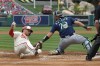 Los Angeles Angels' Brandon Drury, left, scores on a single by Matt Thaiss as Seattle Mariners catcher Cal Raleigh makes a late tag during the first inning of a baseball game Sunday, June 11, 2023, in Anaheim, Calif. (AP Photo/Mark J. Terrill)