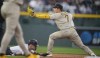 San Diego Padres second baseman Ha-Seong Kim, right, fields the throw to put out Colorado Rockies' Brendan Doyle at second base on the back end of a double play hit into by Ezequiel Tovar to end the eighth inning of a baseball game, Sunday, June 11, 2023, in Denver. (AP Photo/David Zalubowski)