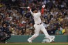Boston Red Sox's Justin Turner, right, follows through on a grand slam against the New York Yankees during the third inning of a baseball game Friday, June 16, 2023, at Fenway Park in Boston. (AP Photo/Winslow Townson)