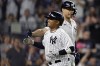 New York Yankees' Willie Calhoun is congratulated by Giancarlo Stanton after hitting a home run against the Boston Red Sox during the sixth inning of a baseball game Saturday, June 10, 2023, in New York. (AP Photo/Adam Hunger)