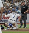Umpire Bruce Dreckman, right, looks on after Tampa Bay Rays' Taylor Walls tagged out Kansas City Royals' Bobby Witt Jr. at third base during the fourth inning of a baseball game Saturday, June 24, 2023, in St. Petersburg, Fla. (AP Photo/Steve Nesius)