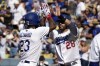 Los Angeles Dodgers' Jason Heyward, left, is congratulated by J.D. Martinez after hitting a two-run home run during the first inning of the team's baseball game against the Houston Astros on Saturday, June 24, 2023, in Los Angeles. (AP Photo/Mark J. Terrill)