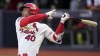 St. Louis Cardinals' Willson Contreras follows through as he singles during the third inning of a baseball game against the Chicago Cubs Sunday, June 25, 2023, in London. (AP Photo/Kin Cheung)