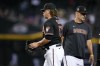 Arizona Diamondbacks relief pitcher Andrew Chafin, left, gets pulled by manager Torey Lovullo during the ninth inning of the team's baseball game against the New York Mets on Wednesday, July 5, 2023, in Phoenix. (AP Photo/Ross D. Franklin)