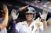 New York Yankees' Giancarlo Stanton is congratulated in the dugout after hitting a home run during the fifth inning of a baseball game against the Chicago Cubs, Saturday, July 8, 2023, in New York. (AP Photo/Adam Hunger)