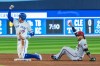 Toronto Blue Jays' George Springer (4) celebrates a double against Arizona Diamondbacks second baseman Ketel Marte (4) during fifth inning MLB baseball action in Toronto on Saturday, July 15, 2023. THE CANADIAN PRESS/Mathew Tsang