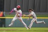 Cincinnati Reds' Elly De La Cruz, left, is tagged out by San Francisco Giants second baseman Brett Wisely as he attempted to steal third base after being caught off second during the ninth inning in the continuation of a baseball game in Cincinnati, Tuesday, July 18, 2023. The game was suspended Monday in the eighth inning due to inclement weather. (AP Photo/Aaron Doster)