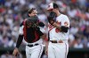 Baltimore Orioles catcher Adley Rutschman, left, and starting pitcher Tyler Wells talk after pitching to the New York Yankees during the first inning of a baseball game, Saturday, July 29, 2023, in Baltimore. (AP Photo/Julio Cortez)