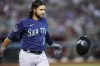 Seattle Mariners' Eugenio Suarez throws his helmet after striking out against the Arizona Diamondbacks during the fourth inning of a baseball game Sunday, July 30, 2023, in Phoenix. (AP Photo/Ross D. Franklin)