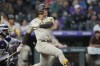 San Diego Padres' Juan Soto follows the flight of his three-run home run against Colorado Rockies relief pitcher Tommy Doyle in the fifth inning of a baseball game Tuesday, Aug. 1, 2023, in Denver. (AP Photo/David Zalubowski)