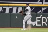 Chicago White Sox center fielder Luis Robert Jr. reaches out to field a single hit by Texas Rangers' Marcus Semien in the first inning of a baseball game, Wednesday, Aug. 2, 2023, in Arlington, Texas. (AP Photo/Tony Gutierrez)