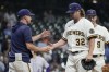 Milwaukee Brewers manager Craig Counsell takes relief pitcher Andrew Chafin out of the game after walking in a run during the 10th inning of a baseball game against the Colorado Rockies Tuesday, Aug. 8, 2023, in Milwaukee. (AP Photo/Morry Gash)