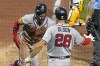 Atlanta Braves' Michael Harris II, left, scores on a popout by Austin Riley against the Pittsburgh Pirates during the eighth inning of a baseball game in Pittsburgh, Wednesday, Aug. 9, 2023. (AP Photo/Gene J. Puskar)