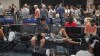 People gather at the Kahului Airport while waiting for flights Wednesday, Aug. 9, 2023, in Kahului, Hawaii. Several thousand Hawaii residents raced to escape homes on Maui as the Lahaina fire swept across the island, killing multiple people and burning parts of a centuries-old town. (AP Photo/Rick Bowmer)