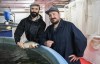 Owner and founders of Opercule fish farm, David Dupaul-Chicoine, left, and Nicolas Paquin hold an Arctic char at their farm in Montreal, Thursday, Aug. 10, 2023. THE CANADIAN PRESS/Graham Hughes.