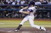 Arizona Diamondbacks' Corbin Carroll connects for a triple against the San Diego Padres during the first inning of a baseball game Sunday, Aug. 13, 2023, in Phoenix. (AP Photo/Ross D. Franklin)