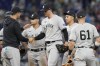 New York Yankees manager Aaron Boone relieves pitcher Clay Holmes during the ninth inning of a baseball game against the Miami Marlins, Sunday, Aug. 13, 2023, in Miami. (AP Photo/Marta Lavandier)