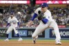 Los Angeles Dodgers first baseman Freddie Freeman makes a catch on a line drive hit by Milwaukee Brewers' Carlos Santana as second baseman Mookie Betts watches during the sixth inning of a baseball game Thursday, Aug. 17, 2023, in Los Angeles. (AP Photo/Mark J. Terrill)