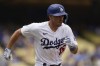 Los Angeles Dodgers' Austin Barnes attempts to run to first after hitting a pop out to Miami Marlins third baseman Jake Burger during the sixth inning in the first baseball game of a doubleheader, Saturday, Aug. 19, 2023, in Los Angeles. (AP Photo/Ryan Sun)