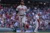 Philadelphia Phillies designated hitter Bryce Harper runs toward home base after Bryson Stott hit a home run during the eighth inning of a baseball game against the Washington Nationals, Saturday, Aug. 19, 2023, in Washington. (AP Photo/Stephanie Scarbrough)